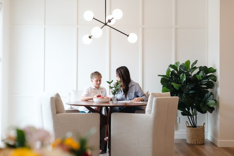 Nicole and her son at their dining room table.